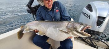 woman on boat holding caught fish